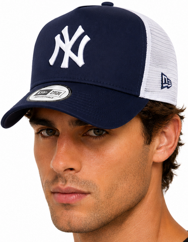A man modeling a navy and white New York Yankees trucker hat, shown from the front and back against a plain white background.