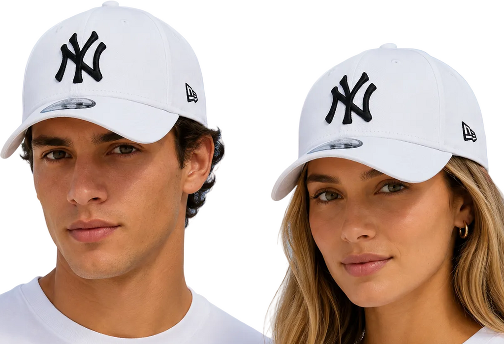 A man and a woman wearing white New York Yankees baseball caps with black embroidered logos, photographed against a light blue sky background.
