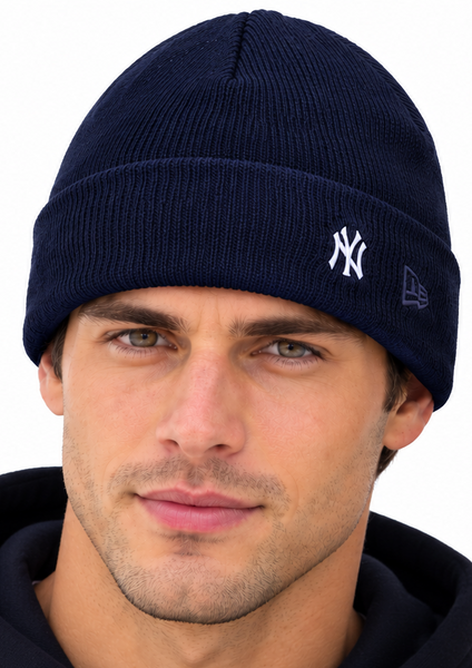 A man and a woman wearing matching navy blue New York Yankees knit beanie hats with white embroidered logos, shown against a plain white background.