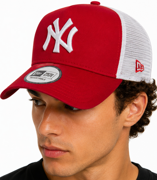 A red and white New York Yankees trucker hat shown on a model from the front and back. The front panel is red with a white embroidered New York Yankees logo, while the back panels are white mesh.