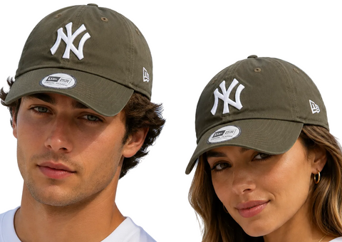 Two models wearing New Era 9FIFTY baseball caps in olive green with a white New York Yankees logo, set against a clear blue sky.